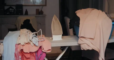 Laundry pile lying messy folded on basket, ready for ironing, iron Stock Footage 139698768