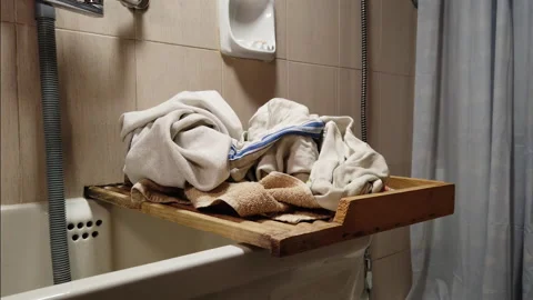 Laundry piling up in the bathroom - Slider shot Stock Footage 220792895
