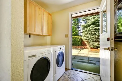 Laundry room with exit to backyard area Stock Photos