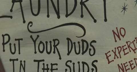 Laundry Room Sign - Put Your Duds in the Suds - Zoom out Stock Footage 86290379