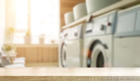 Laundry room table background. Blurred home laundry room with wooden table Stock Photos