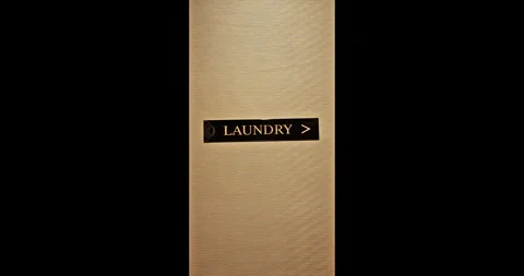 Laundry sign mounted on hotel wall, directional arrow, commercial Stock Footage 347697604