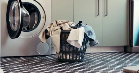 Laundry, washing machine and basket with clothes in home for maintenance Stock Footage 312783466