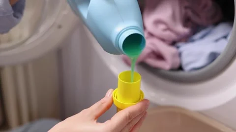 Laundry in washing machine, woman loading clothes, household cleaning and Stock Footage 346402999