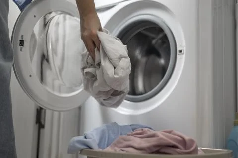 Laundry in washing machine, woman loading clothes, household cleaning and Foto stock