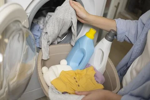 Laundry in washing machine, woman loading clothes, household cleaning and Foto stock