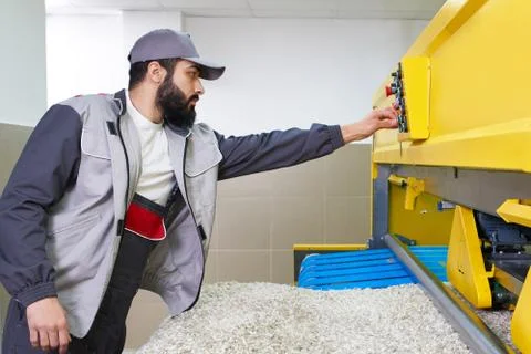 Laundry worker in the process of working on automatic machine for carpet washing Stock Photos