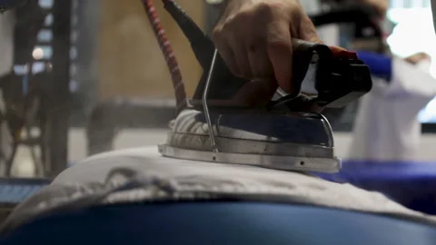 Laundry, workers ironing clothes, lots of steam Stock Footage 283808365