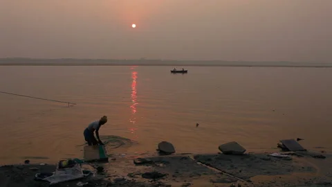 Laundryman washes the fabric on Ganges river Stock Footage 132973668