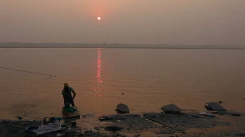 Laundryman washes the fabric on Ganges river Stock Footage 132973771
