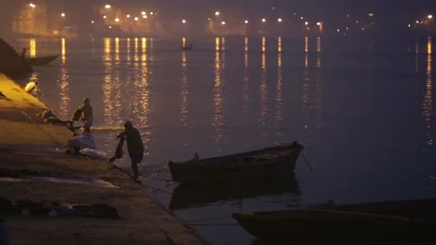Laundryman washes the fabric on Ganges river Stock Footage 132974225