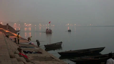 Laundryman washes the fabric on Ganges river Stock Footage 132975158