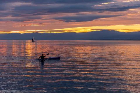 Lausanne, Switzerland - November 02, 2020: Paddling on the lake at golden hour Stock Photos
