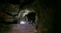 Lava Caves 12 Man get in small hole HD Footage
