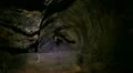 Lava Caves 13 Man get in small hole HD Footage