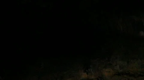 Lava Caves 14 woman get in small hole Stock Footage