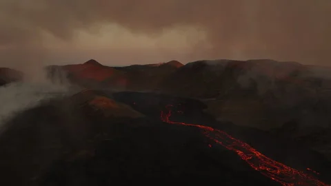 Lava flow through Icelandic valley at dusk, aerial view Stock Footage 258283951