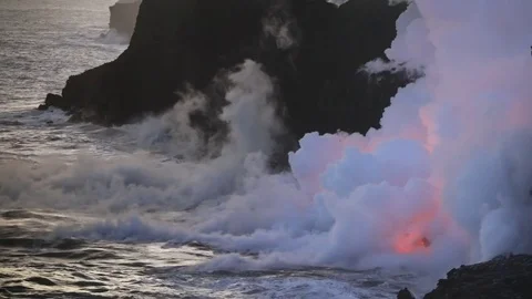 Lava flows after sunset into the ocean, steam cloud rising from water surface Video stock 80679351