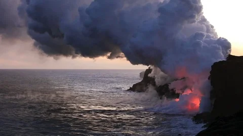 Lava flows after sunset into the ocean, steam cloud rising from water surface Video stock 80679372