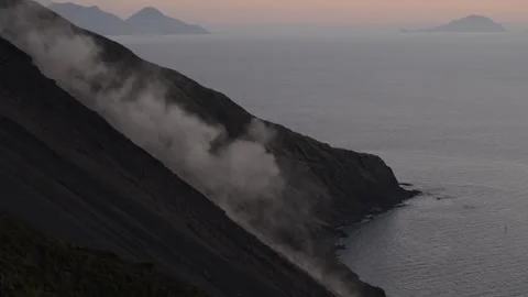 Lava flows down the side of the  stromboli volcano into the sea Stock Footage 272636825