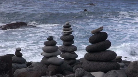 Lava pebbles placed on top of each other by the ocean, Tenerife, Stock Footage 57501276