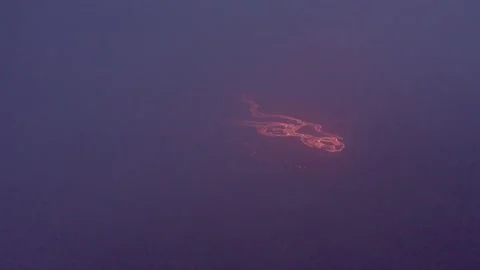 Lava river appears through cloud at night Stock Footage 211786782