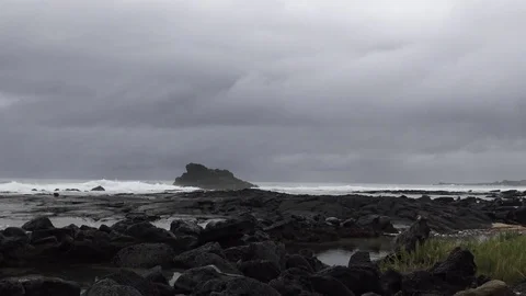 Lava rocks on the oceanfront Grey cloudy day Stock Footage 81642212