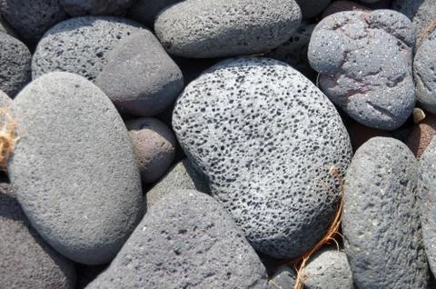 Lava rocks, rounded by the ocean Stock Photos