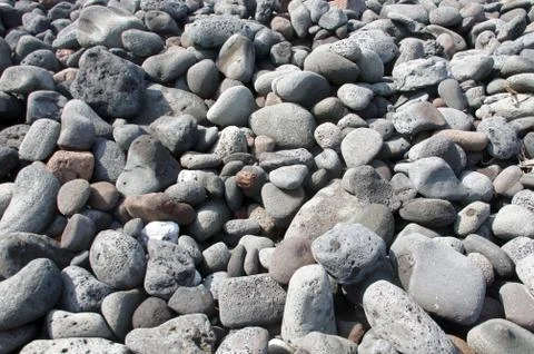Lava rocks, rounded by the ocean Stock Photos