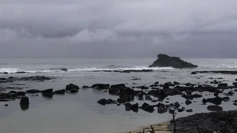 Lava rocks in tidal pool as waves crash with sound 스톡 동영상 81646445