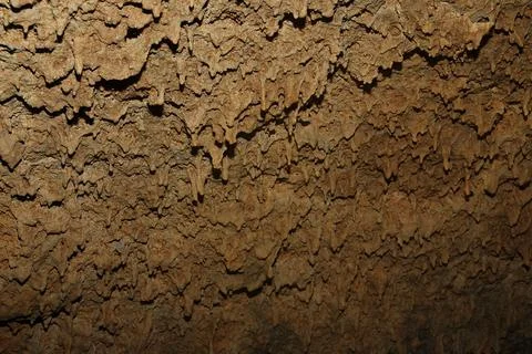 Lava stalactites in the ceiling of a cave. Stock Photos