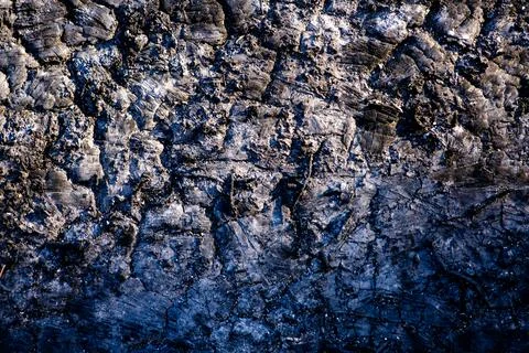 Lava texture background with dark volcanic surface. Lava macro closeup with.. Stock Photos