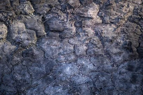 Lava texture with black basalt surface. Lava macro detail with rough cracks.  Stock Photos