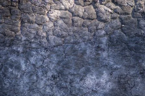 Lava volcanic rock with rough surface texture. Lava macro detail with crack p Stock Photos