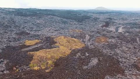 Lava volcano spread across the ground. Killed all living things. Aerial Filming Stock Footage 72719578