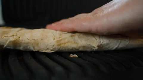 Lavash is placed on an electric grill, close-up Stock Footage 313464854