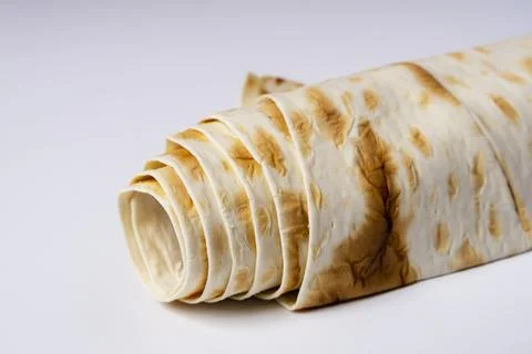 Lavash rolled on a white background, thin traditional oriental bread, Armenia Stock Photos