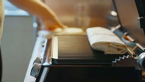 Lavash with stuffing is placed on an open hot electric grill for further cooking Stock Footage 238701862