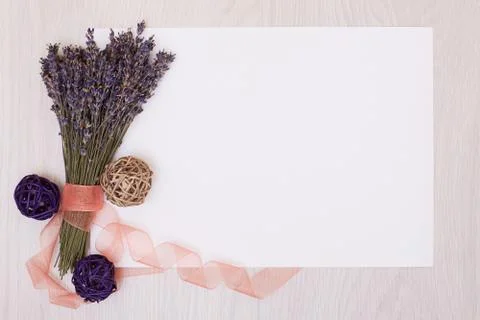 Lavender desk with flowers on background top view mock up.White paper postcar Stock Photos