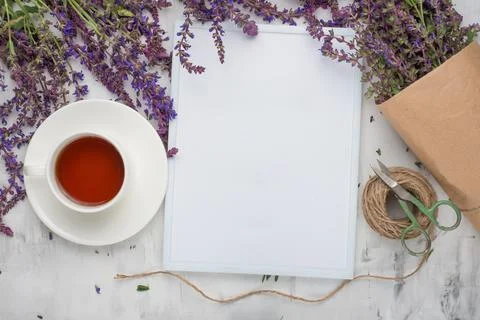 Lavender flowers with an empty frame and a cup of tea. Top view with empty sp Stock Photos