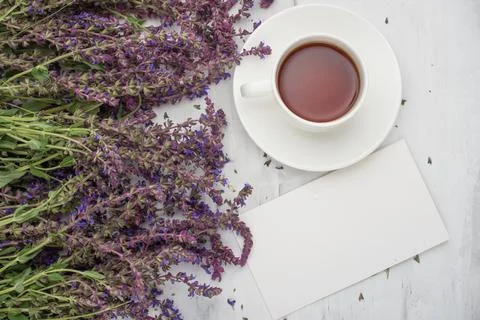 Lavender flowers with an empty frame and a cup of tea. Top view with empty sp Stock Photos