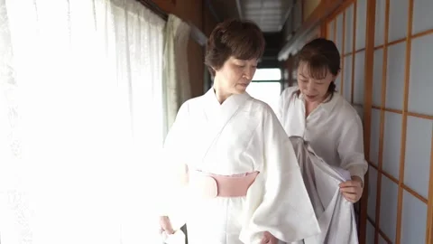 Lavender kimono placed over a white underlayer Stock Footage 344013755