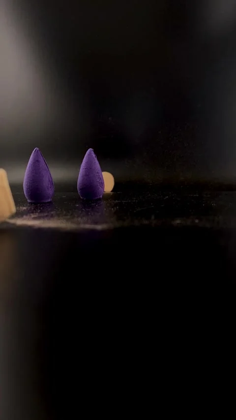Lavender, leaf and incense in glass vase on reflective black surface Stock Footage 321308244