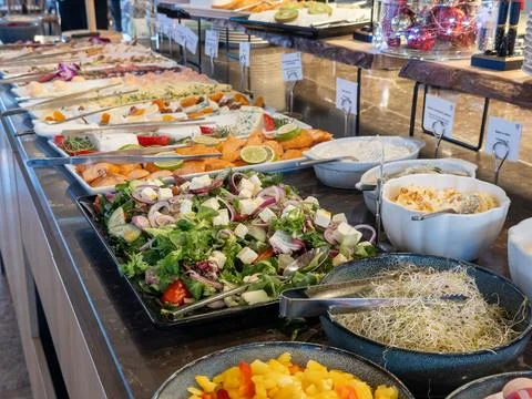 A lavish breakfast buffet spread with diverse healthy salads, fresh salmon, and Stock Photos
