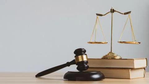 Law and justice concept. Mallet of the judge, scales and stack books with c.. Stock Photos