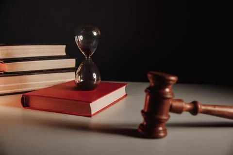 Law code. Hourglass with red book and judge gavel Stock Photos