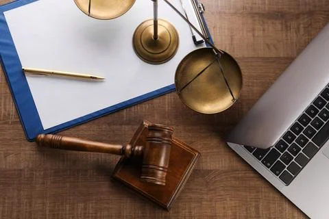 Law concept. Flat lay composition with scales of justice and mallet on wood.. Stock Photos