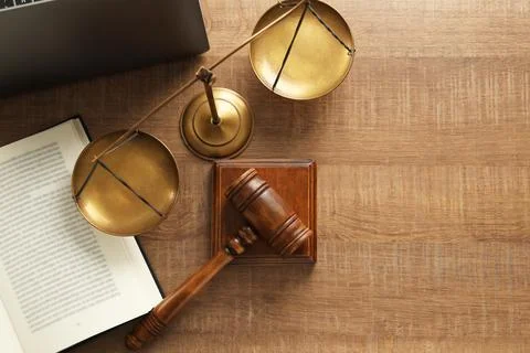 Law concept. Gavel, book and scales of justice on wooden table, flat lay. S.. Stock Photos