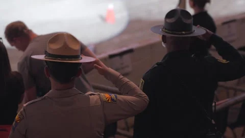 Law enforcement saluting during event Stock Footage 255384500