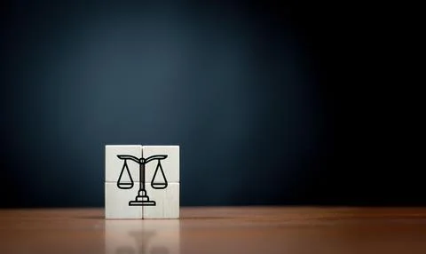Law flat icon on cube block on wooden table over dark background . Stock Photos